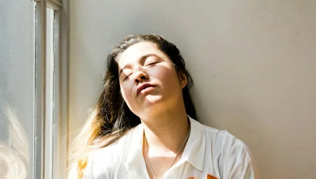 woman standing near window during daytime